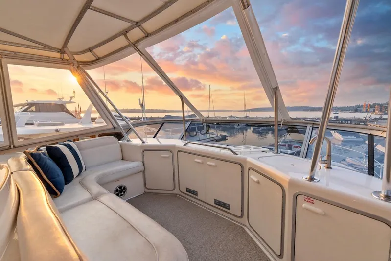 Too Many Options Yacht Photos Pics Luxurious 1993 Sea Ray 550 Sedan Bridge yacht interior with sunset marina view.