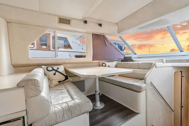 Too Many Options Yacht Photos Pics Luxurious interior of 1993 Sea Ray 550 Sedan Bridge yacht with sunset view.