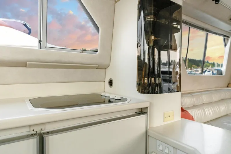 Too Many Options Yacht Photos Pics Interior of 1993 Sea Ray 550 Sedan Bridge yacht with modern kitchen and scenic window view.