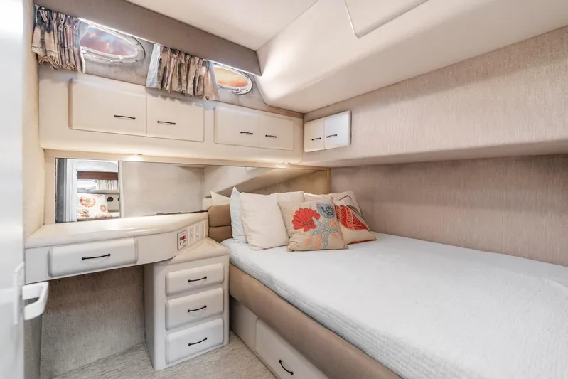 Too Many Options Yacht Photos Pics Cozy cabin interior of 1993 Sea Ray 550 Sedan Bridge with bed and storage.