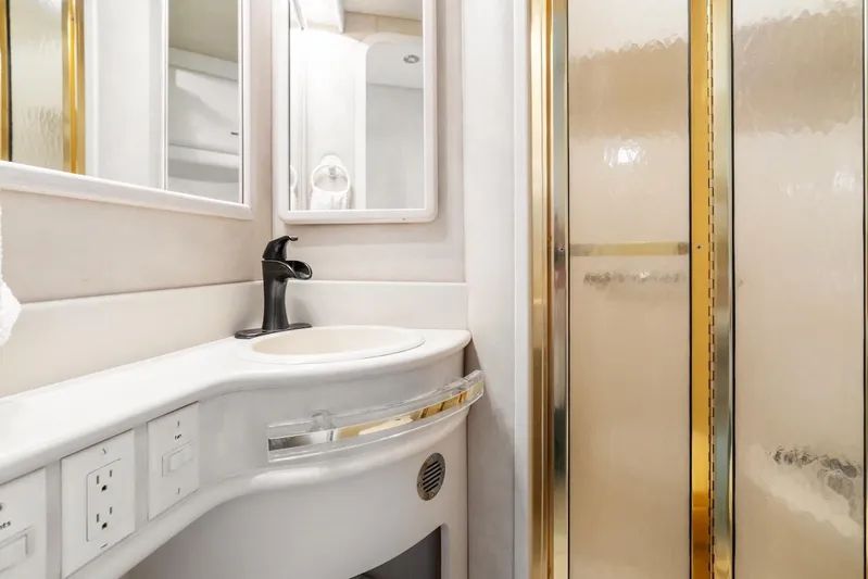 Too Many Options Yacht Photos Pics Luxurious bathroom in 1993 Sea Ray 550 Sedan Bridge yacht with gold accents.