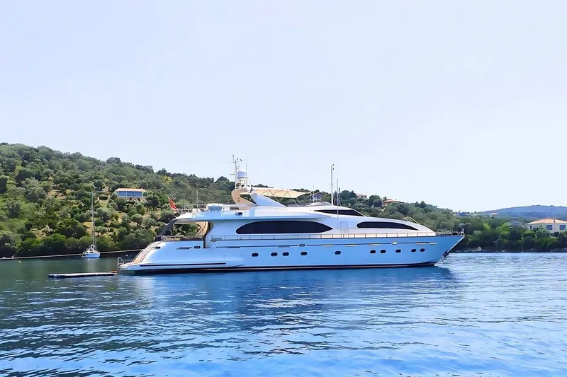 M/y Balkan Yacht Photos Pics Luxurious 2007 Falcon 102 yacht cruising near scenic coastline.