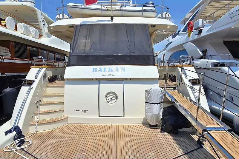 M/y Balkan Yacht Photos Pics Luxurious 2007 Falcon 102 yacht docked, featuring elegant wooden deck and sleek design.