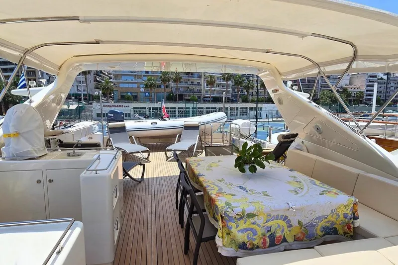 M/y Balkan Yacht Photos Pics Luxurious 2007 Falcon 102 yacht deck with dining area and marina view.