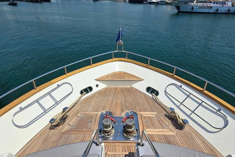 M/y Balkan Yacht Photos Pics Bow view of 2007 Falcon 102 yacht with wooden deck and calm waters.