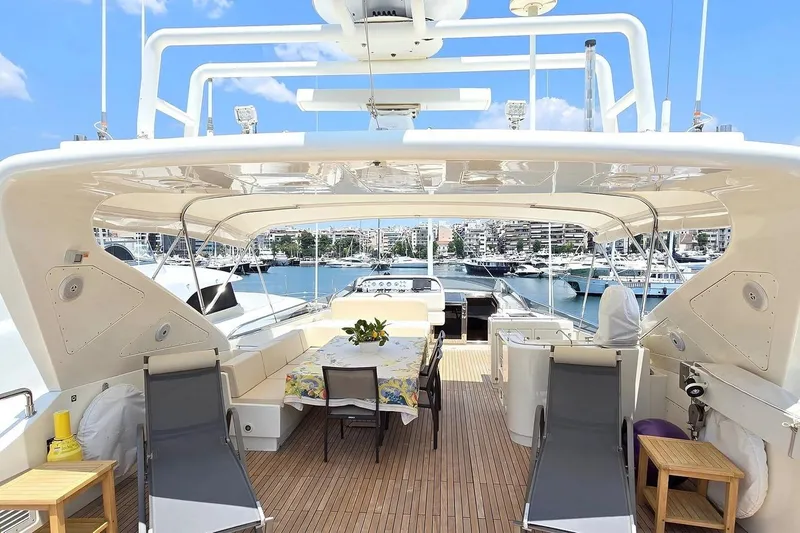 M/y Balkan Yacht Photos Pics Luxurious 2007 Falcon 102 yacht deck with seating, table, and marina view.
