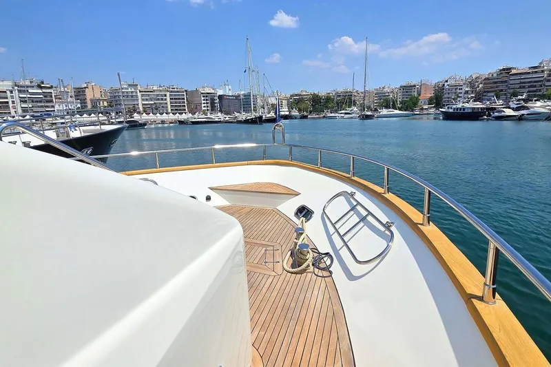 M/y Balkan Yacht Photos Pics Luxury yacht Falcon 102, 2007 model, docked in a scenic marina with cityscape views.