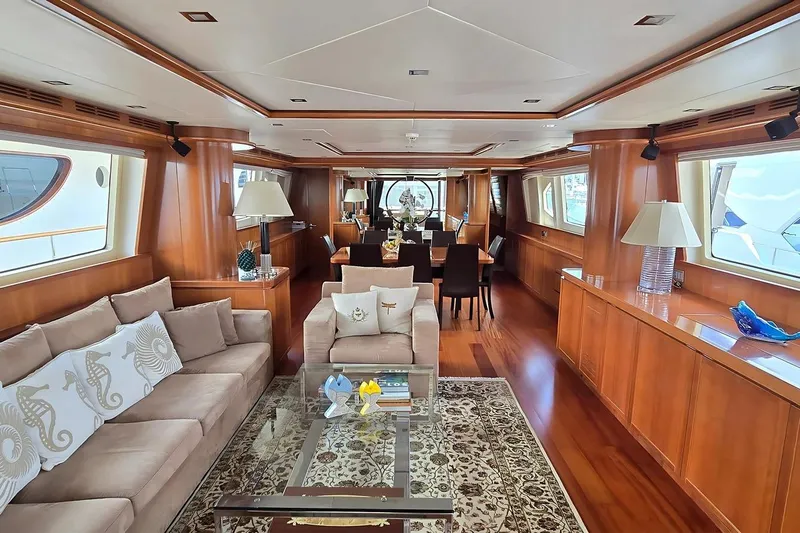 M/y Balkan Yacht Photos Pics Luxurious interior of 2007 Falcon 102 yacht with elegant wood finishes and plush seating.