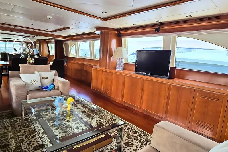 M/y Balkan Yacht Photos Pics Luxurious yacht interior with elegant wood paneling, plush seating, and a flat-screen TV, Falcon 102, 2007.