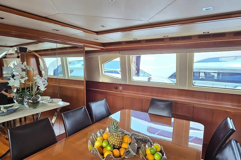 M/y Balkan Yacht Photos Pics Luxurious dining area on 2007 Falcon 102 yacht with fruit centerpiece and elegant decor.
