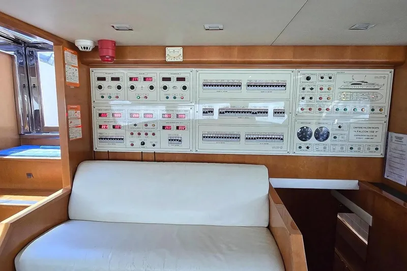 M/y Balkan Yacht Photos Pics Control panel of a 2007 Falcon 102 yacht with seating area.