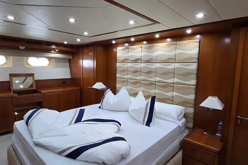 M/y Balkan Yacht Photos Pics Luxurious bedroom interior on 2007 Falcon 102 yacht with elegant wood paneling and modern lighting.
