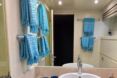 M/y Balkan Yacht Photos Pics Luxurious bathroom with blue towels, modern sink, and elegant lighting on a Falcon 102 yacht.