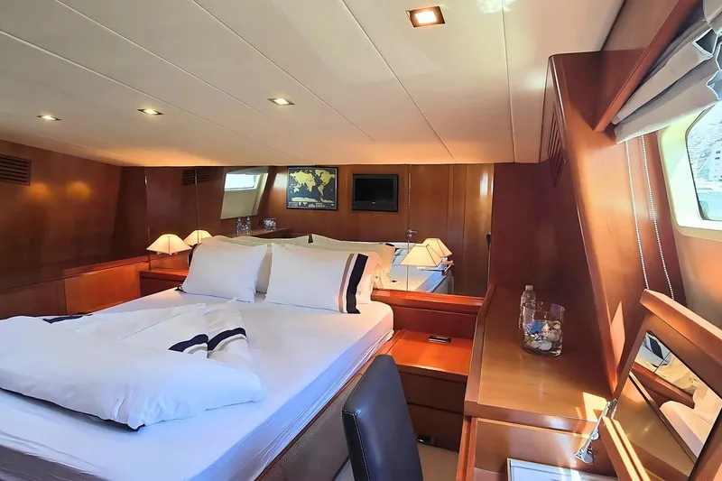 M/y Balkan Yacht Photos Pics Luxurious cabin interior of 2007 Falcon 102 yacht with elegant wood finishes and cozy bedding.