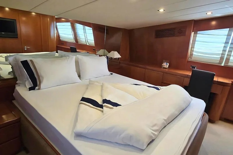M/y Balkan Yacht Photos Pics Luxurious bedroom interior on 2007 Falcon 102 yacht with elegant wood paneling.