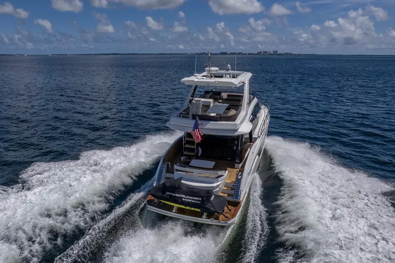Mangogo Yacht Photos Pics 2021 Galeon 500 Fly yacht cruising on open water under a clear sky.