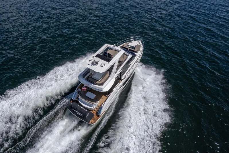 Mangogo Yacht Photos Pics Aerial view of 2021 Galeon 500 Fly yacht cruising on open water.