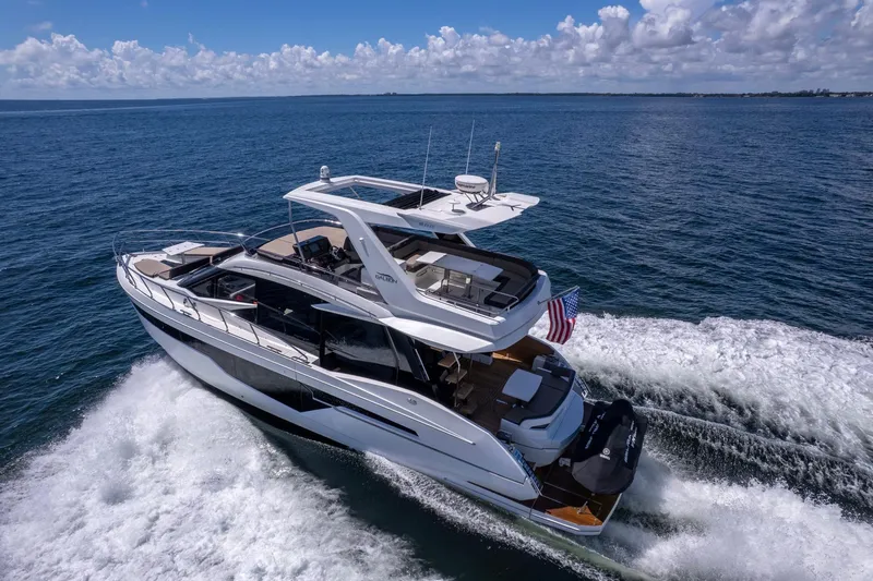 Mangogo Yacht Photos Pics 2021 Galeon 500 Fly yacht cruising on open sea under clear skies.