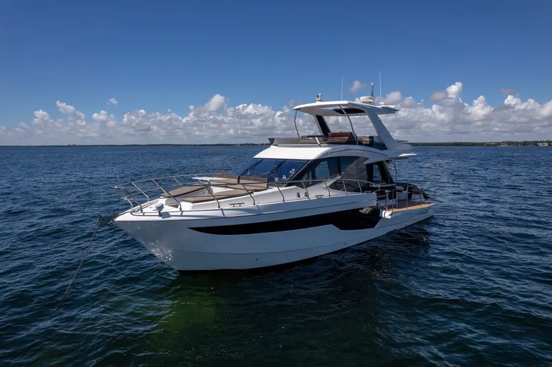 Mangogo Yacht Photos Pics 2021 Galeon 500 Fly yacht on open water under clear blue sky.