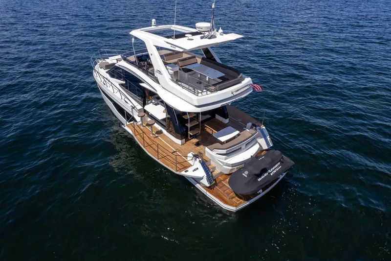 Mangogo Yacht Photos Pics 2021 Galeon 500 Fly yacht cruising on open water, showcasing luxurious design and spacious deck.