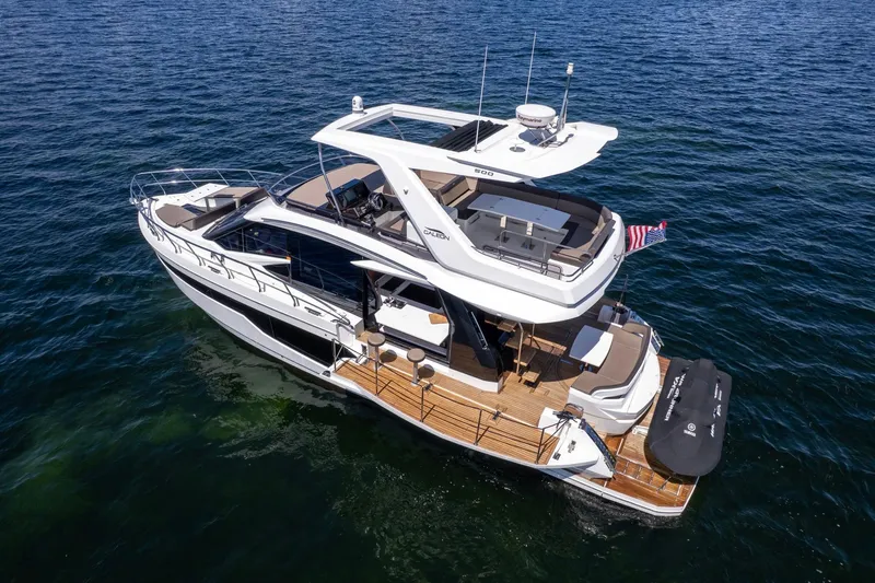 Mangogo Yacht Photos Pics 2021 Galeon 500 Fly yacht cruising on open water, showcasing sleek design and luxury features.