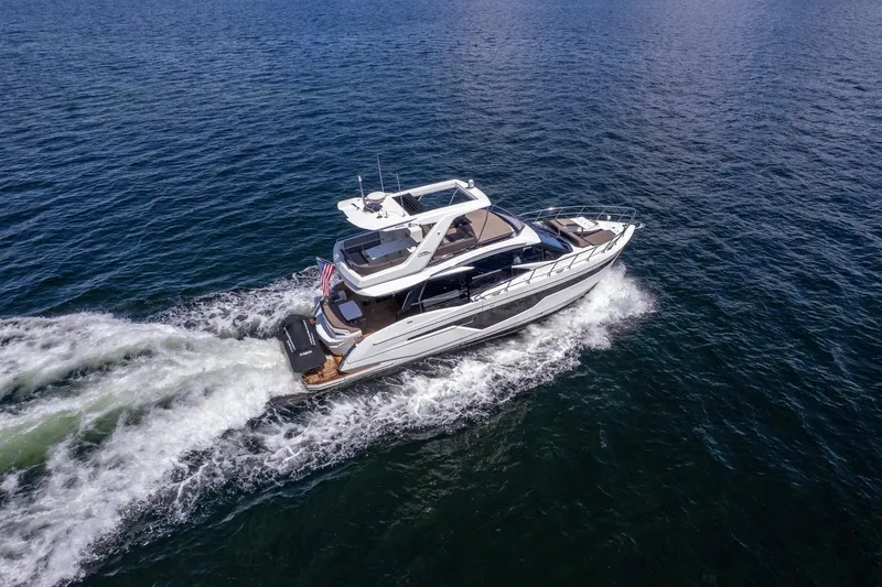 Mangogo Yacht Photos Pics 2021 Galeon 500 Fly yacht cruising on open water, aerial view.