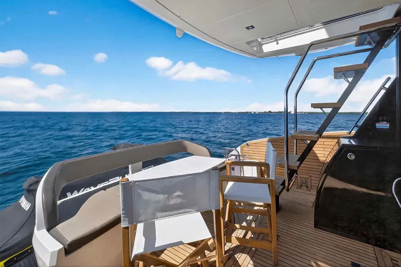 Mangogo Yacht Photos Pics Luxury Galeon 500 Fly yacht deck with ocean view, featuring elegant seating and stairs, 2021 model.