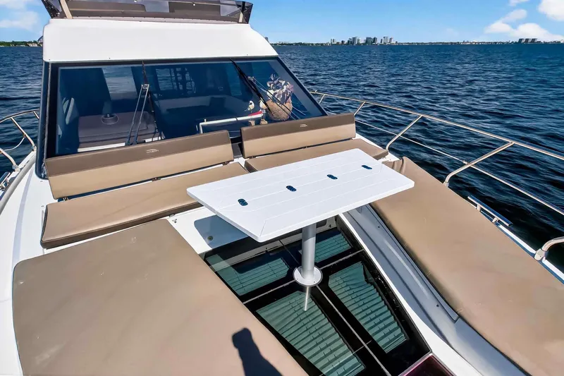 Mangogo Yacht Photos Pics 2021 Galeon 500 Fly yacht with sunbathing area and table on open water.