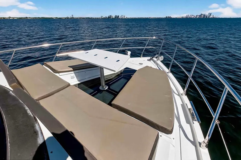 Mangogo Yacht Photos Pics 2021 Galeon 500 Fly yacht deck with sun loungers and table, ocean view.