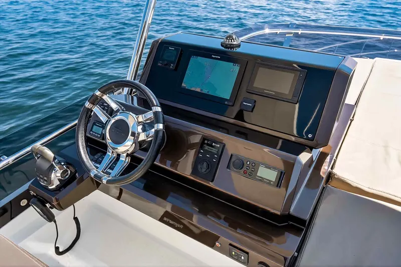Mangogo Yacht Photos Pics Helm of 2021 Galeon 500 Fly yacht with navigation controls and steering wheel.