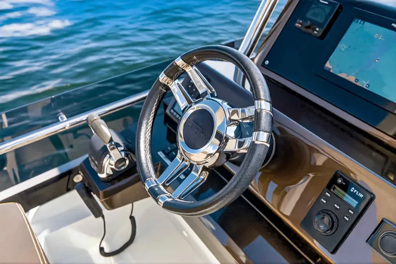 Mangogo Yacht Photos Pics Steering wheel and controls of 2021 Galeon 500 Fly yacht, with navigation display.