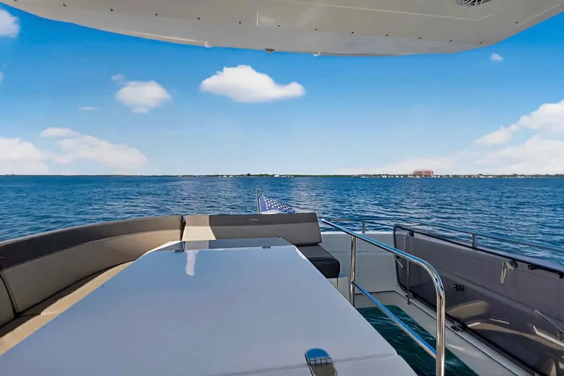 Mangogo Yacht Photos Pics Luxurious 2021 Galeon 500 Fly yacht deck with ocean view under clear blue sky.