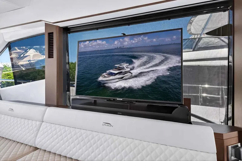 Mangogo Yacht Photos Pics Luxurious interior of 2021 Galeon 500 Fly yacht with large TV and elegant seating.