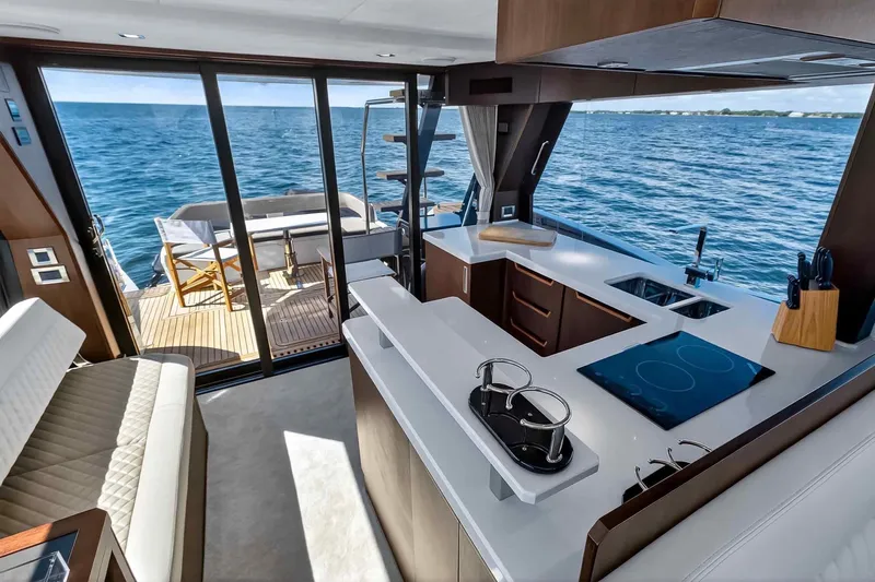 Mangogo Yacht Photos Pics Luxurious interior of 2021 Galeon 500 Fly yacht with modern kitchen and ocean view.