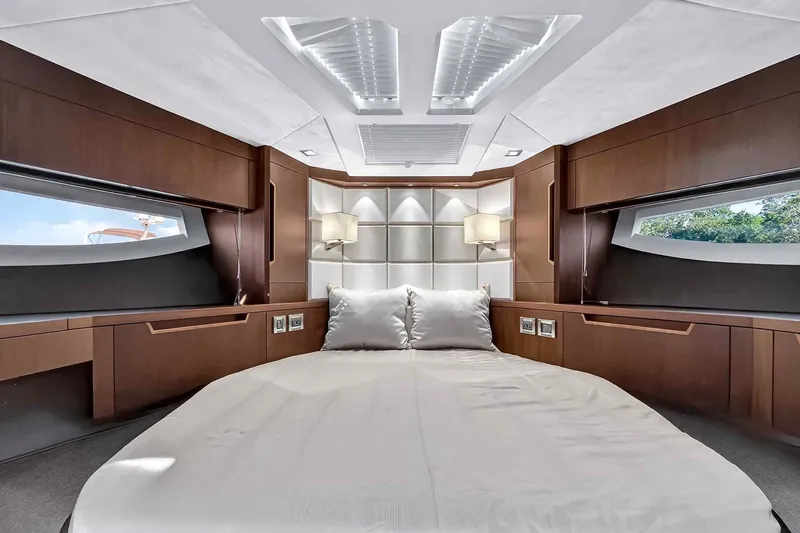 Mangogo Yacht Photos Pics Luxurious interior of 2021 Galeon 500 Fly yacht with modern wood finishes and elegant bedding.