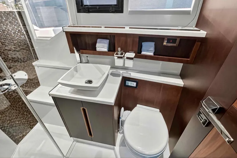 Mangogo Yacht Photos Pics Luxurious bathroom interior of 2021 Galeon 500 Fly yacht, featuring modern sink and toilet.