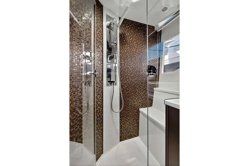 Mangogo Yacht Photos Pics Luxurious shower in 2021 Galeon 500 Fly yacht with mosaic tiles and modern fixtures.