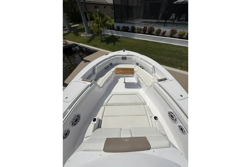  Yacht Photos Pics 2024 Bertram 39 CC boat interior with cushioned seating and wooden table.