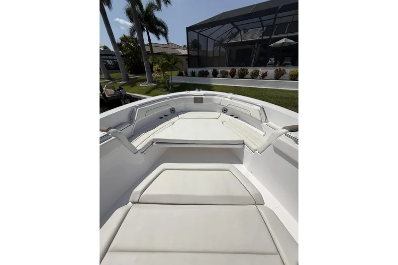  Yacht Photos Pics 2024 Bertram 39 CC boat interior with white cushioned seating and modern design.