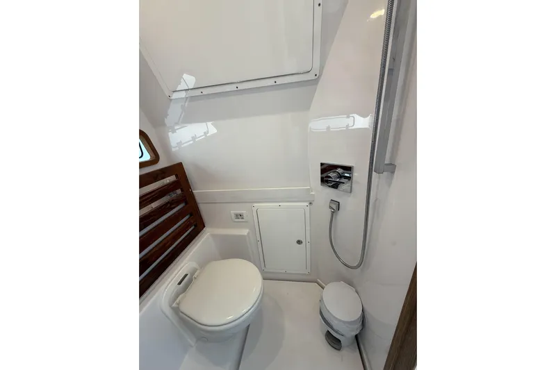  Yacht Photos Pics 2024 Bertram 39 CC boat bathroom with modern fixtures and compact design.
