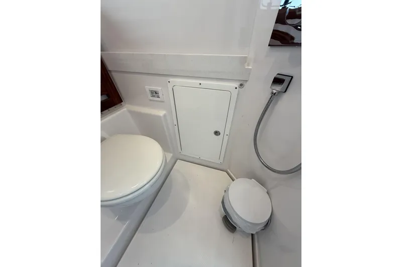  Yacht Photos Pics 2024 Bertram 39 CC boat bathroom with toilet and showerhead.