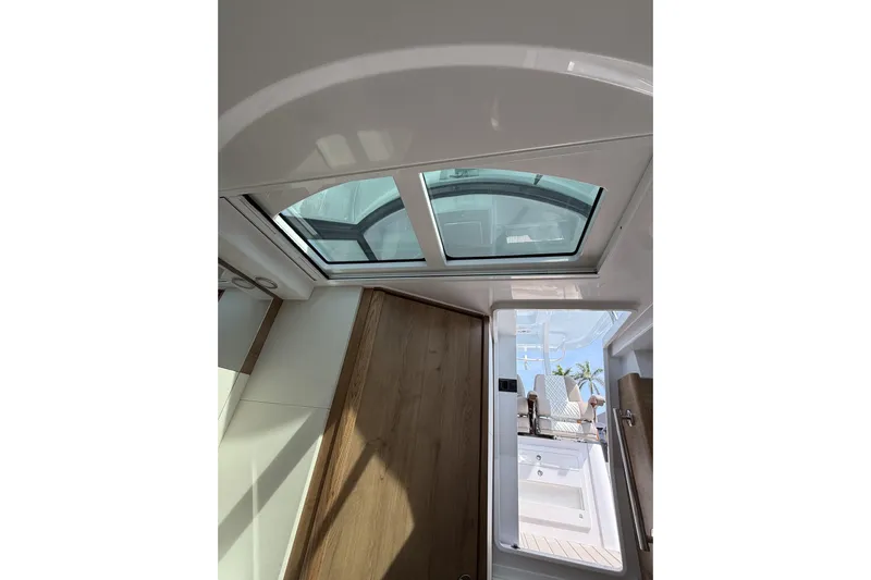  Yacht Photos Pics Interior view of 2024 Bertram 39 CC boat with skylight and wooden accents.