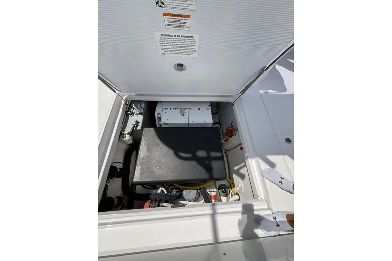  Yacht Photos Pics 2024 Bertram 39 CC engine compartment with visible components and safety instructions.