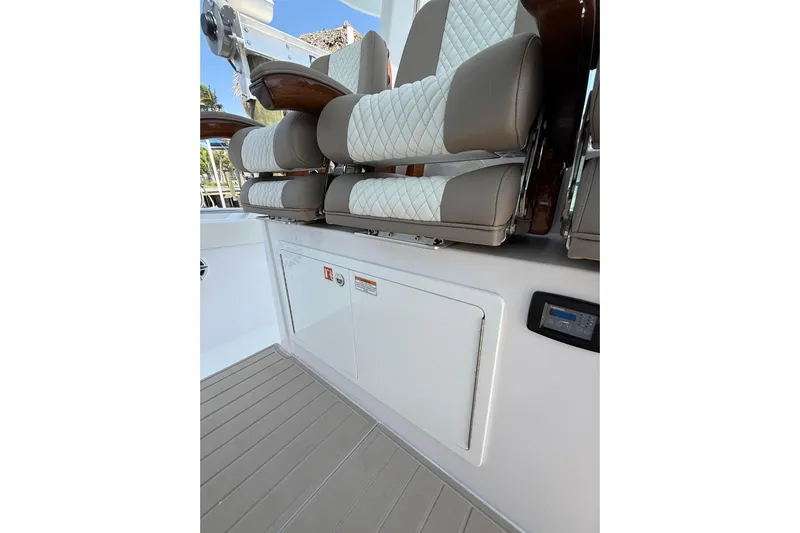  Yacht Photos Pics 2024 Bertram 39 CC boat interior with cushioned seating and control panel.