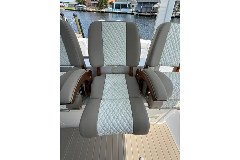  Yacht Photos Pics 2024 Bertram 39 CC boat seats with quilted upholstery, dockside view.