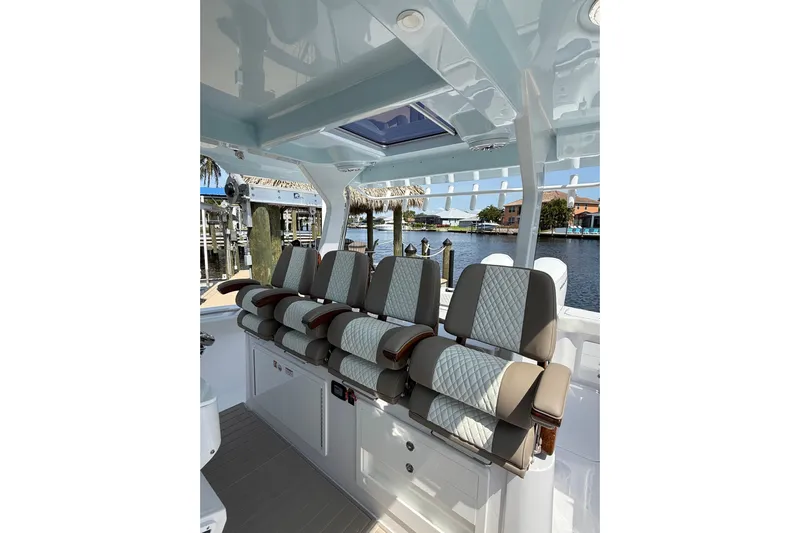  Yacht Photos Pics Interior of 2024 Bertram 39 CC boat with luxurious seating and waterfront view.