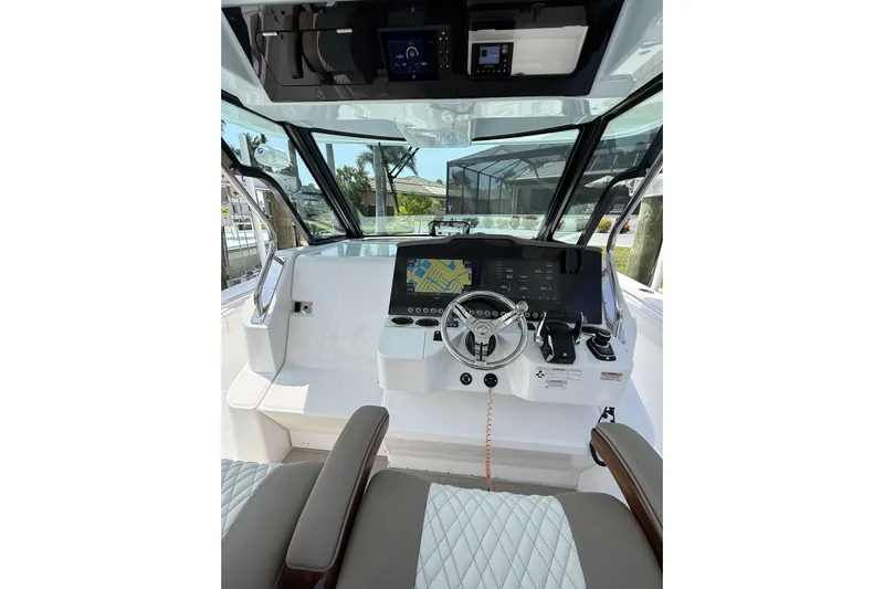  Yacht Photos Pics 2024 Bertram 39 CC boat cockpit with modern steering and navigation system.