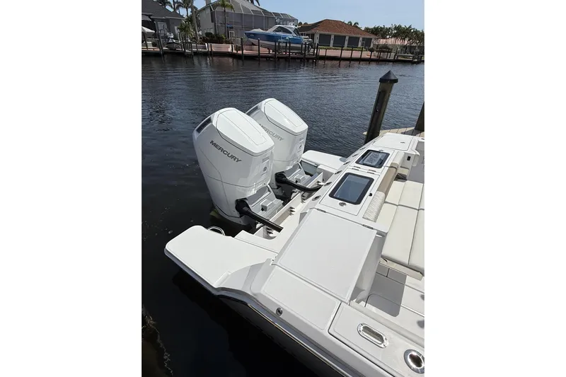  Yacht Photos Pics 2024 Bertram 39 CC boat with dual Mercury outboard engines docked by the water.