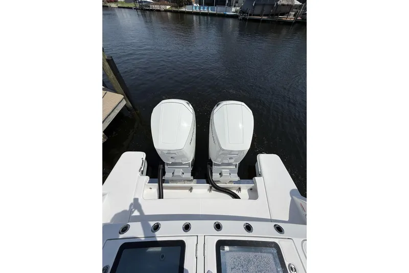  Yacht Photos Pics 2024 Bertram 39 CC boat with dual outboard engines on calm water.