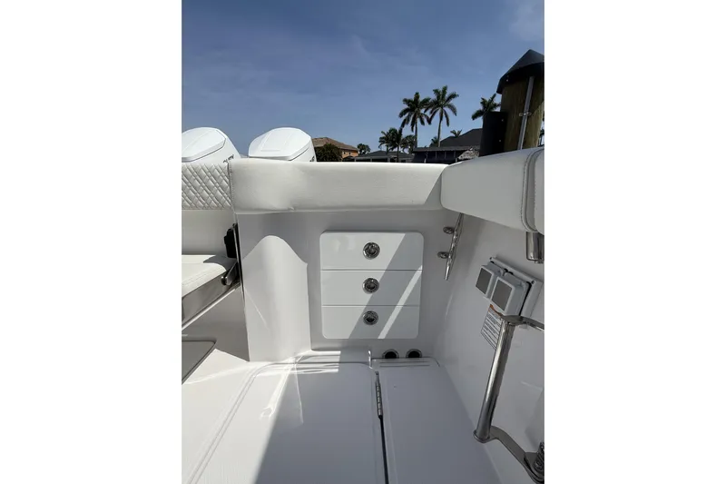  Yacht Photos Pics 2024 Bertram 39 CC boat interior with sleek white seating and storage compartments.
